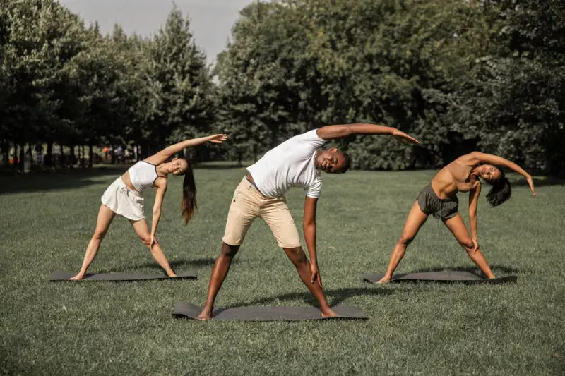 Three students practising together on the grass